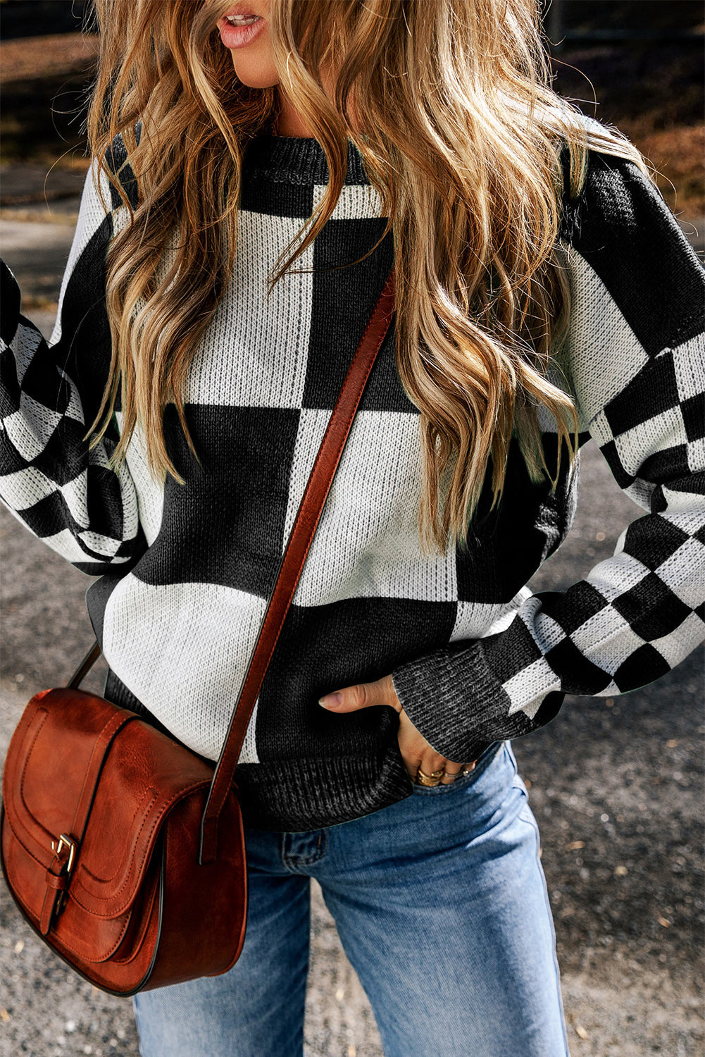 a woman wearing a green and white sweater and jeans