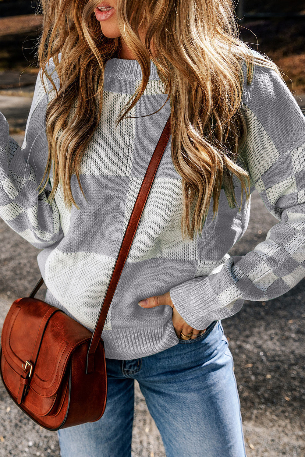 a woman wearing a black and white checkered sweater