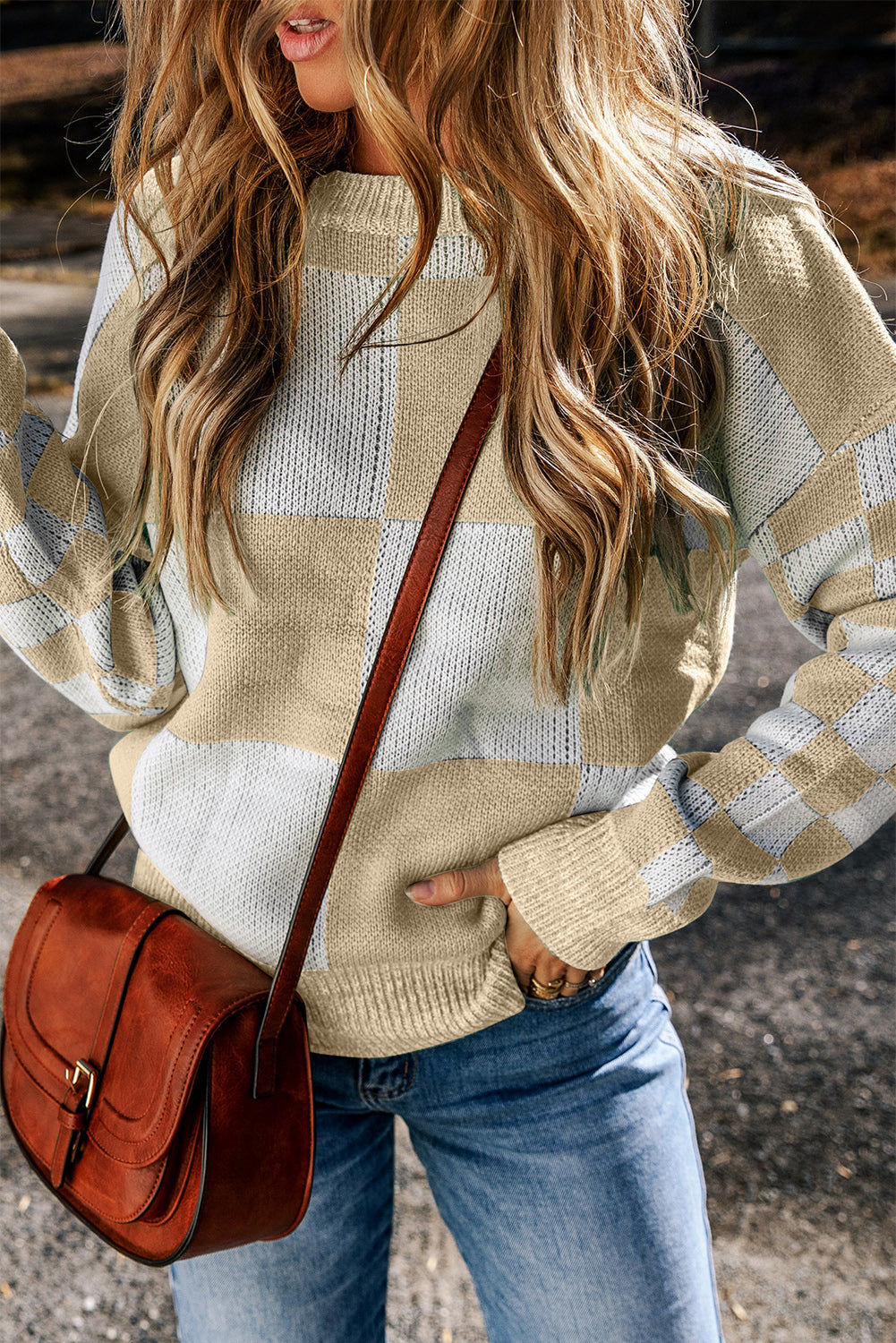 a green and white checkered sweater hanging on a wall